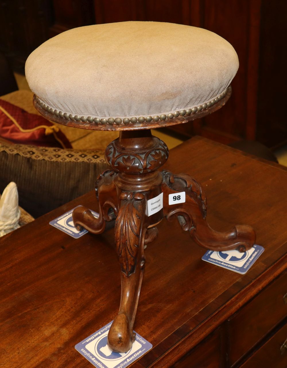 A Victorian circular topped revolving piano stool